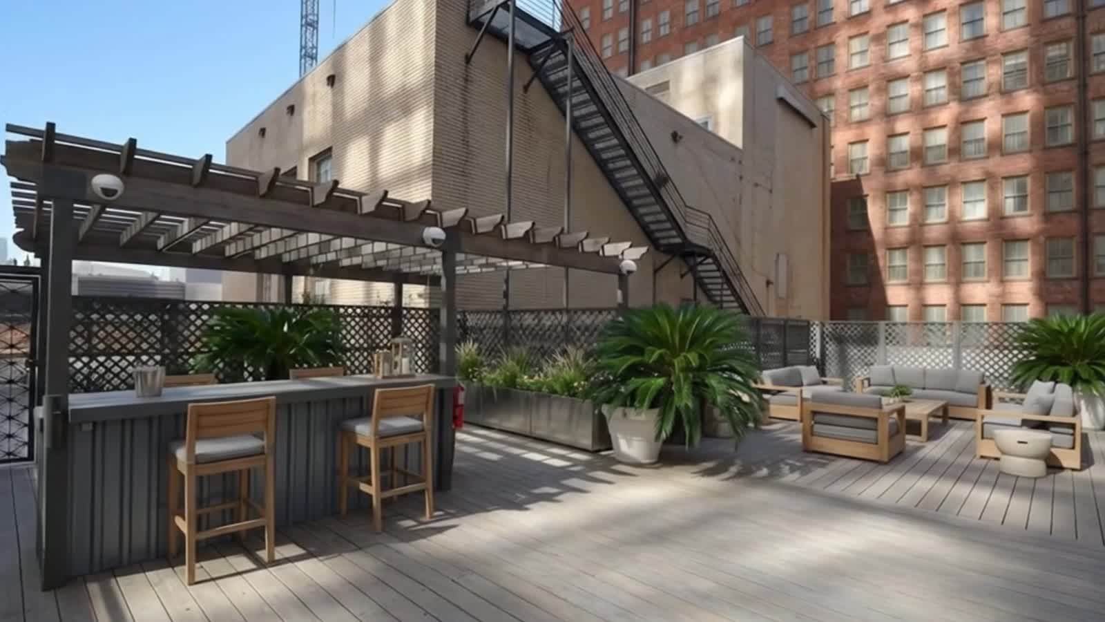 Rooftop terrace with pergola bar and lounge seating